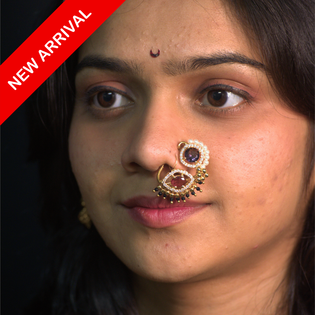 Nath Yesurai Grace
Fuchsia and amethyst nath
Maharashtrian bridal nath
Eye-shaped and round motif nose ring
Hand-set pearl and crystal nath
Gold-plated festive nath
Designer traditional nose ring
Statement bridal accessory
Ethnic wedding nath
Grand Maharashtrian jewelry