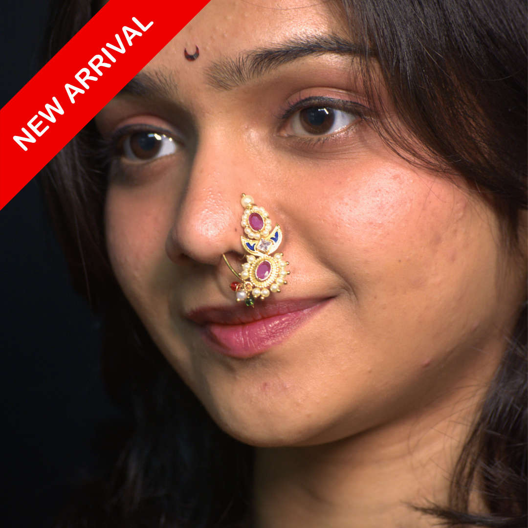 Nath Putalai Heritage
Maharashtrian bridal nath
Pink stone nath
Pearl embellished nath
Traditional Maharashtrian nose ring
Wedding nose ring jewelry
Festive bridal nath
Vertical motif nath
Gold plated nath
Ethnic Maharashtrian jewelry